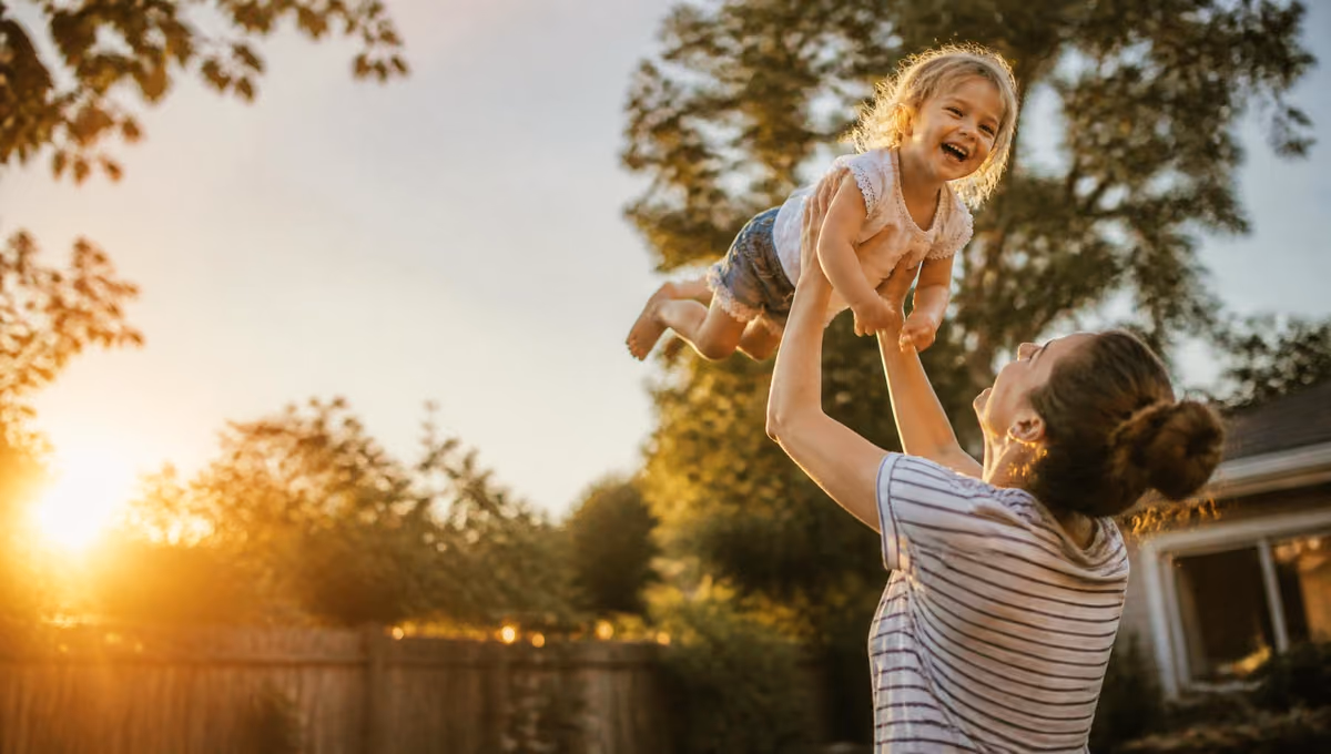 Parent and child sharing a joyful moment outdoors